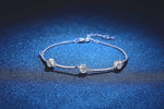 Silver bracelet featuring three bezel-set round moissanite stones