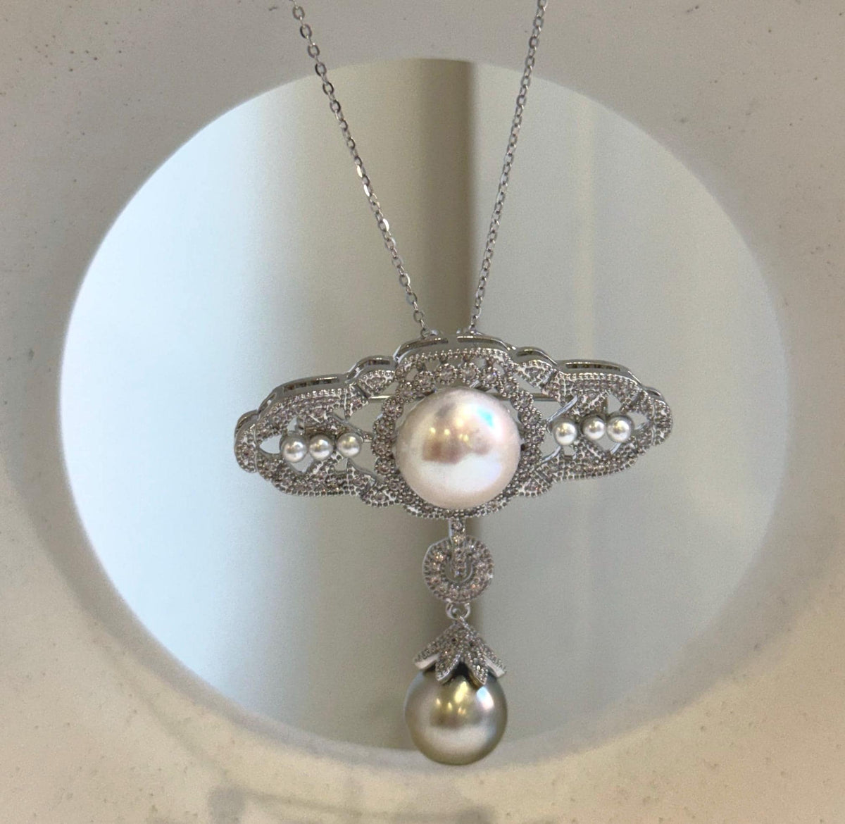 Statement pearl brooch with small pearl accents and shimmering silver-tone details