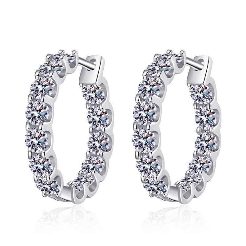 S925 sterling silver moissanite hoop earrings displayed on a textured blue background.
