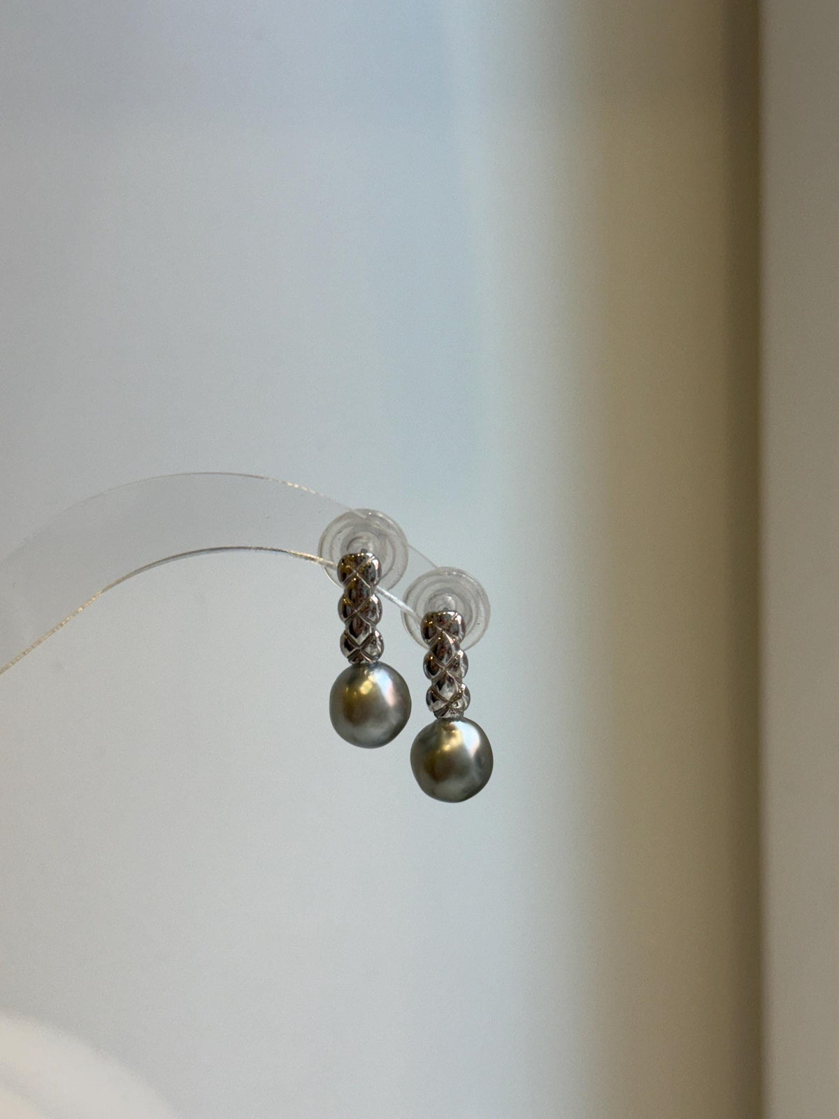 Front view of gray pearl drop earrings showing rounded 9mm pearls and polished sterling silver settings.