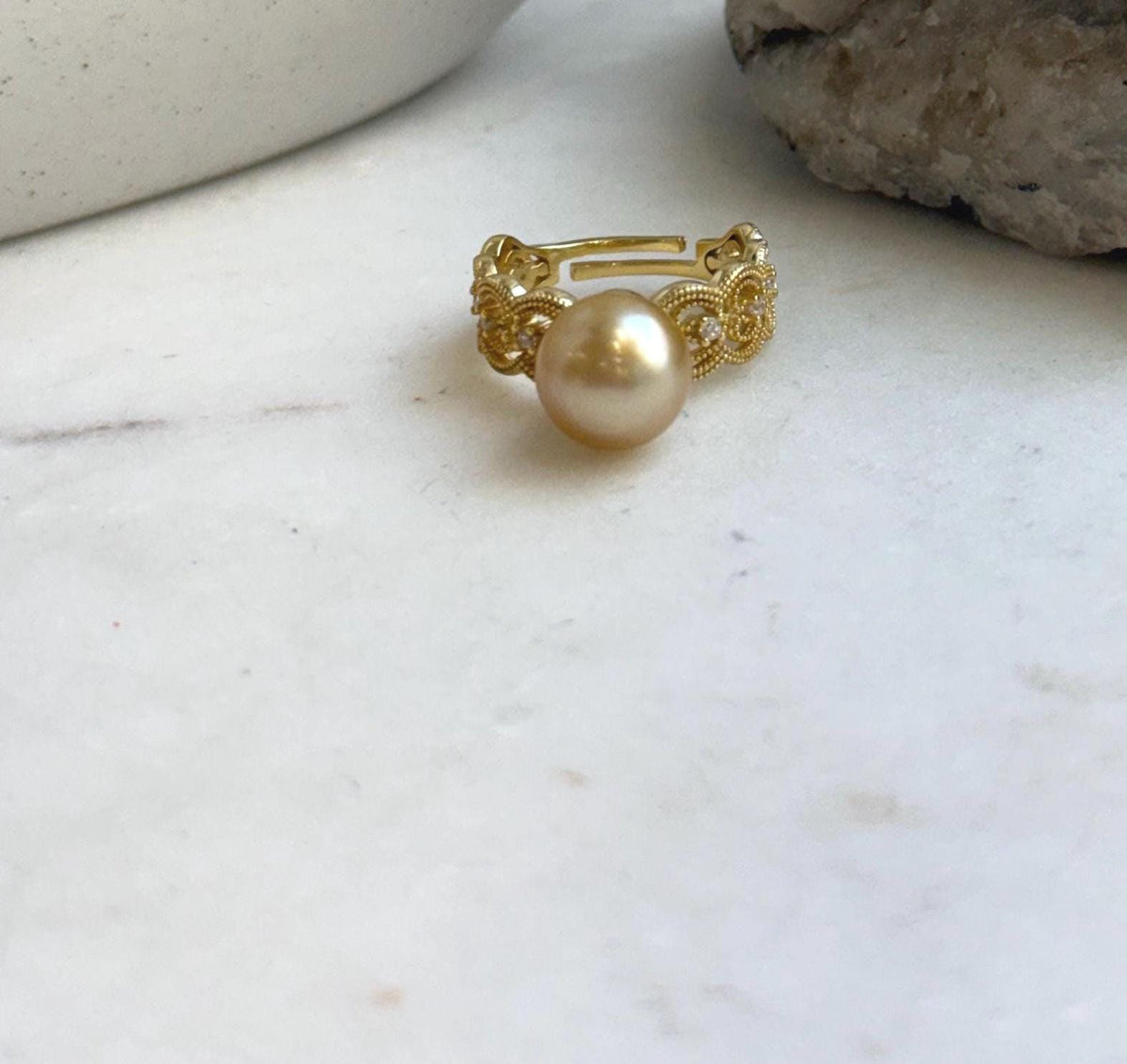 A 10.2mm golden South Sea pearl set on a minimalist adjustable ring with gold plating over S925 sterling silver.