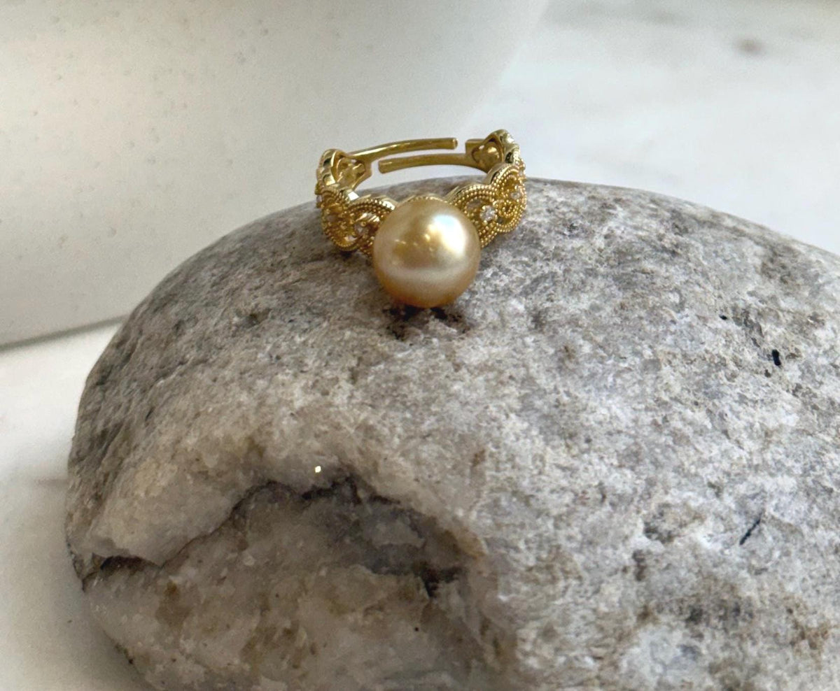 Elly’s adjustable South Sea pearl ring featuring warm tea-gold color, bright luster and a gold-plated silver lace band.