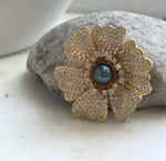 Lustrous hunter blue Tahitian pearl in a flower-inspired brooch pendant