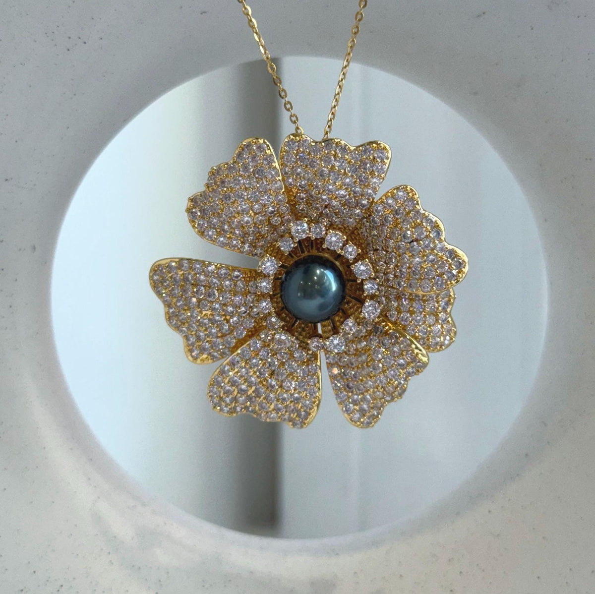 Versatile floral brooch and pendant featuring a genuine Tahitian pearl