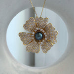 Versatile floral brooch and pendant featuring a genuine Tahitian pearl
