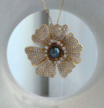 Floral pendant brooch with a hunter blue Tahitian saltwater pearl
