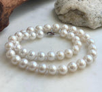 10.1–11.9mm white Edison pearls arranged in a classic necklace strand.