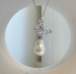 Lustrous white ocean baroque pearl pendant on a sterling silver chain.