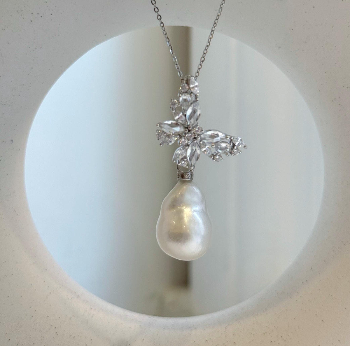 Lustrous white ocean baroque pearl pendant on a sterling silver chain.