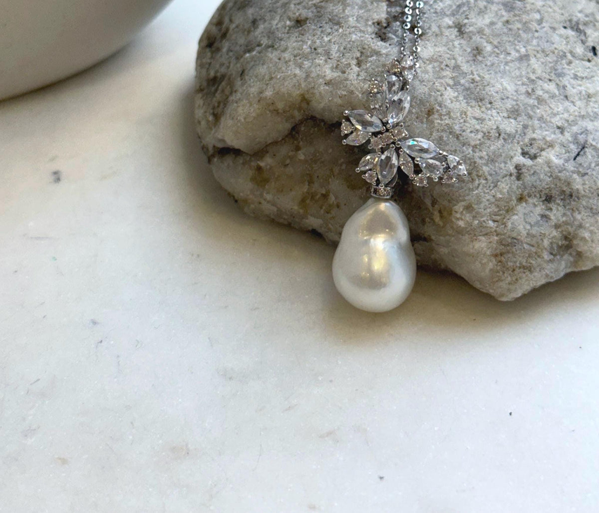 Butterfly ocean pearl necklace with sparkling clear accents.