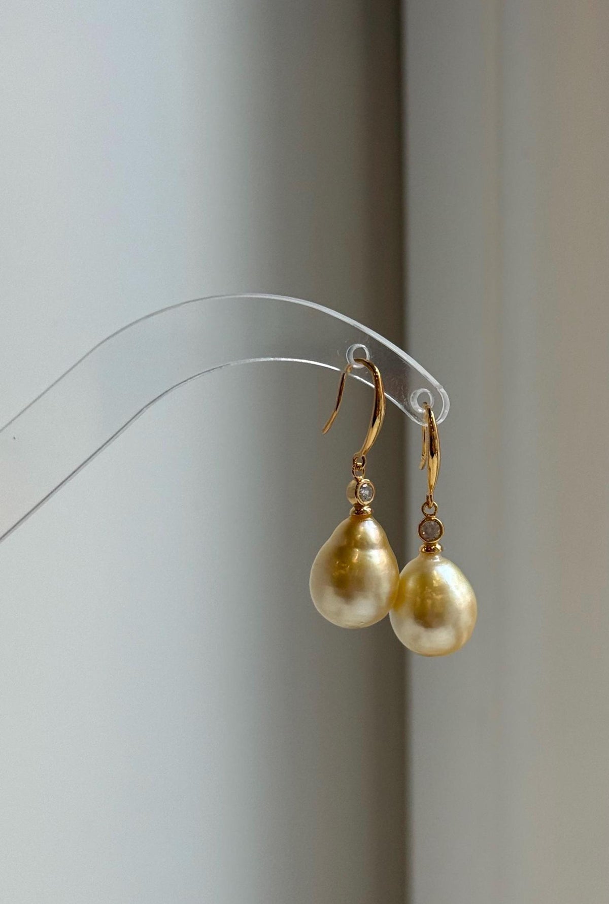 Golden South Sea pearl earrings with a lustrous reflective surface.