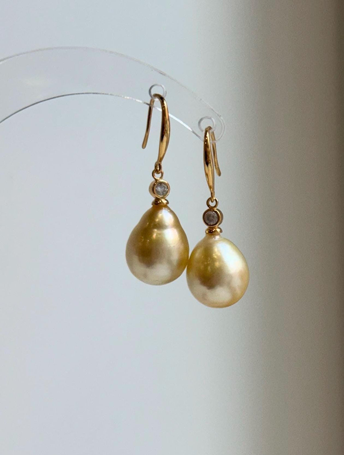 S925 sterling silver hook earrings featuring golden saltwater pearls.