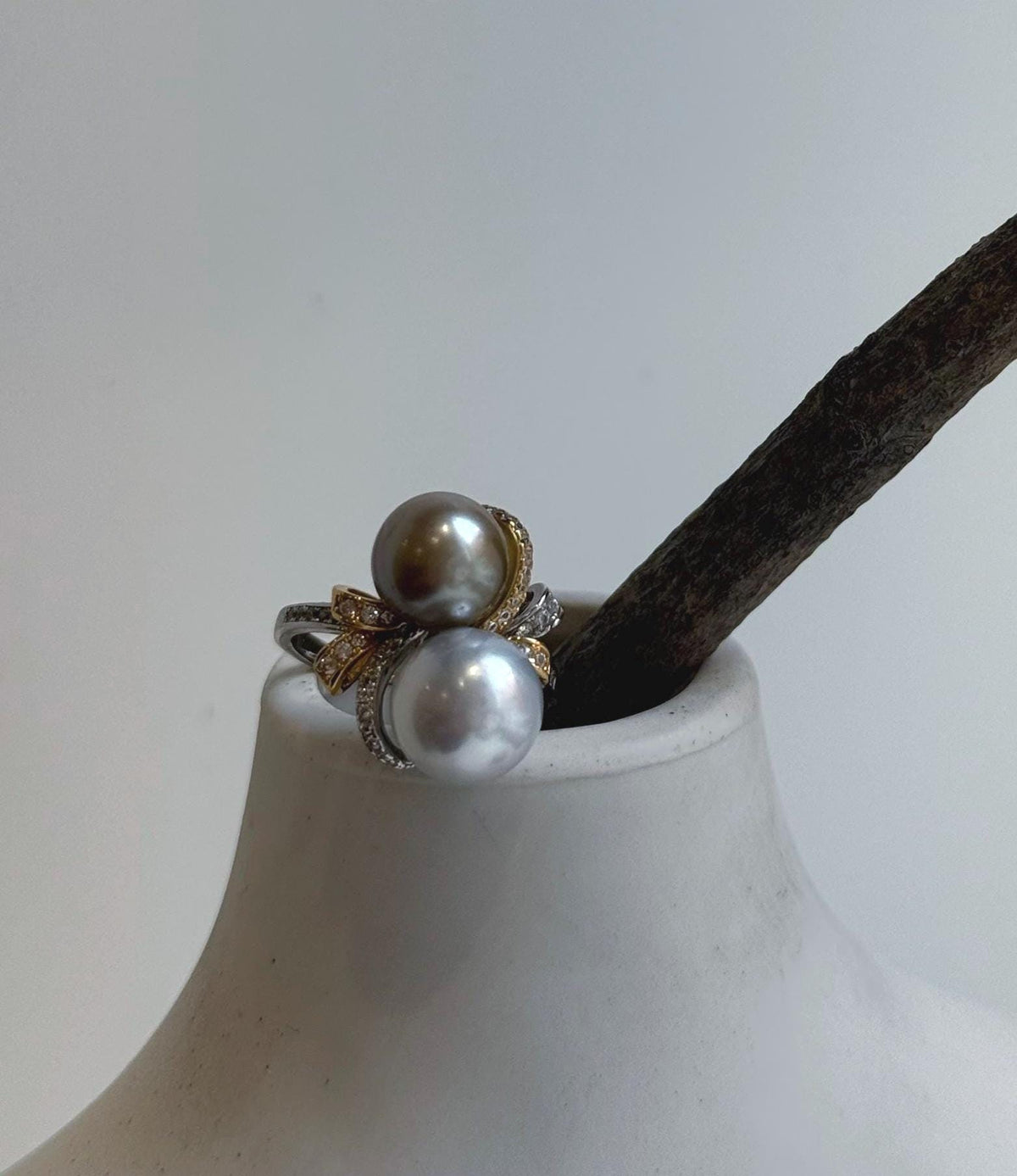 Two silver taupe saltwater pearls paired with a sterling silver floral design.
